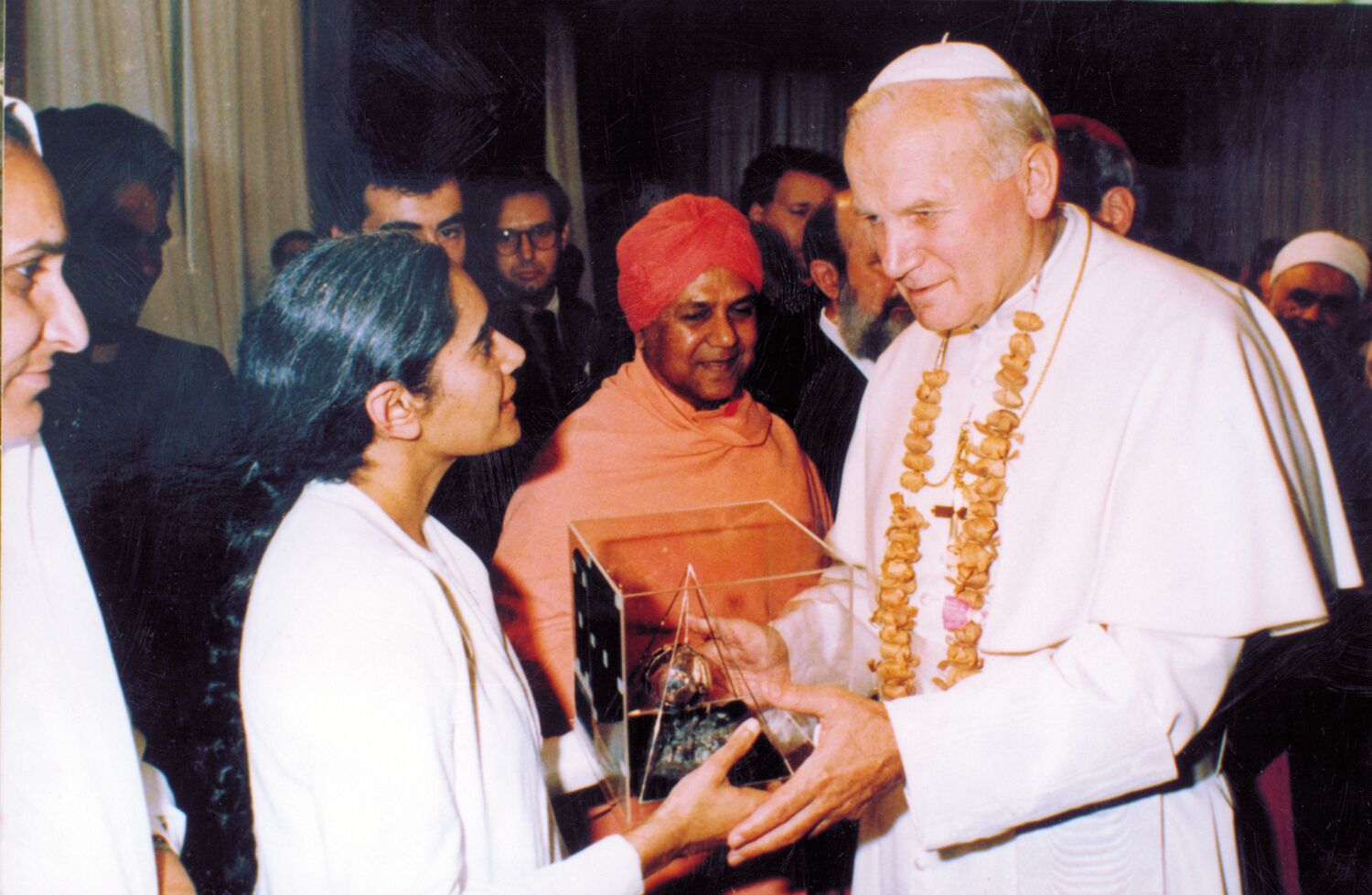 Interfaith event at the Vatican, Rome. Sister Jayanti presented Pope John Paul II a gift from the Brahma Kumaris which came from the Community of Saint Egidio in Poland. It was a sculpture that depicted rays of light over the globe. 1987